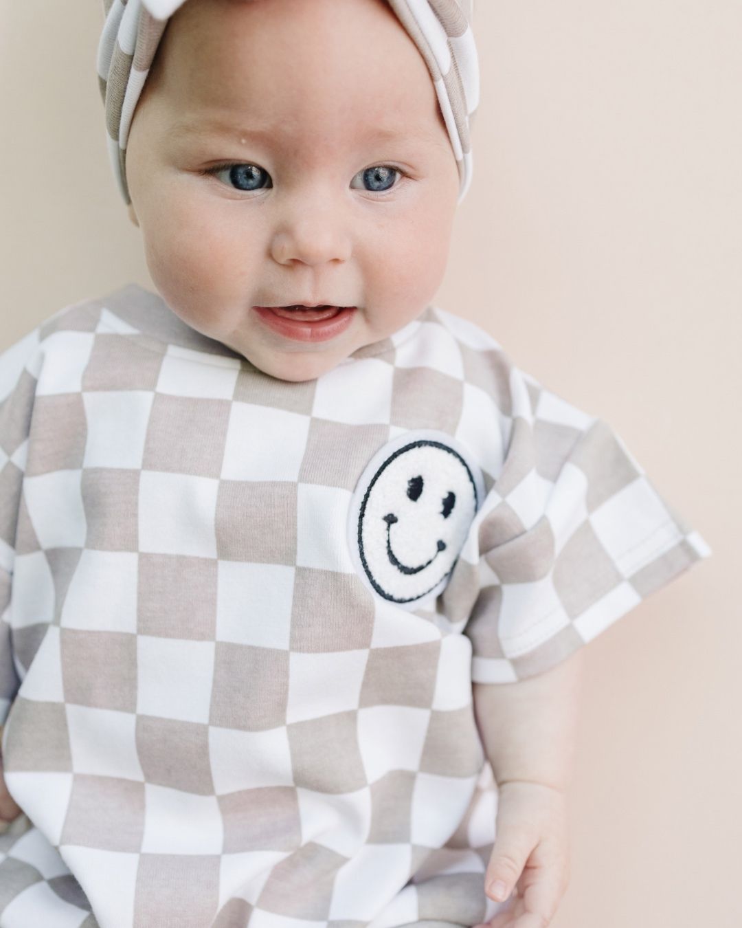 short sleeve bubble romper // checkered smiley latte