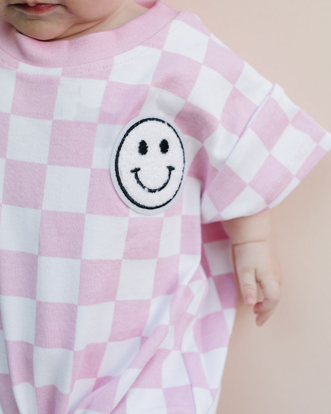 short sleeve bubble romper // checkered smiley pink