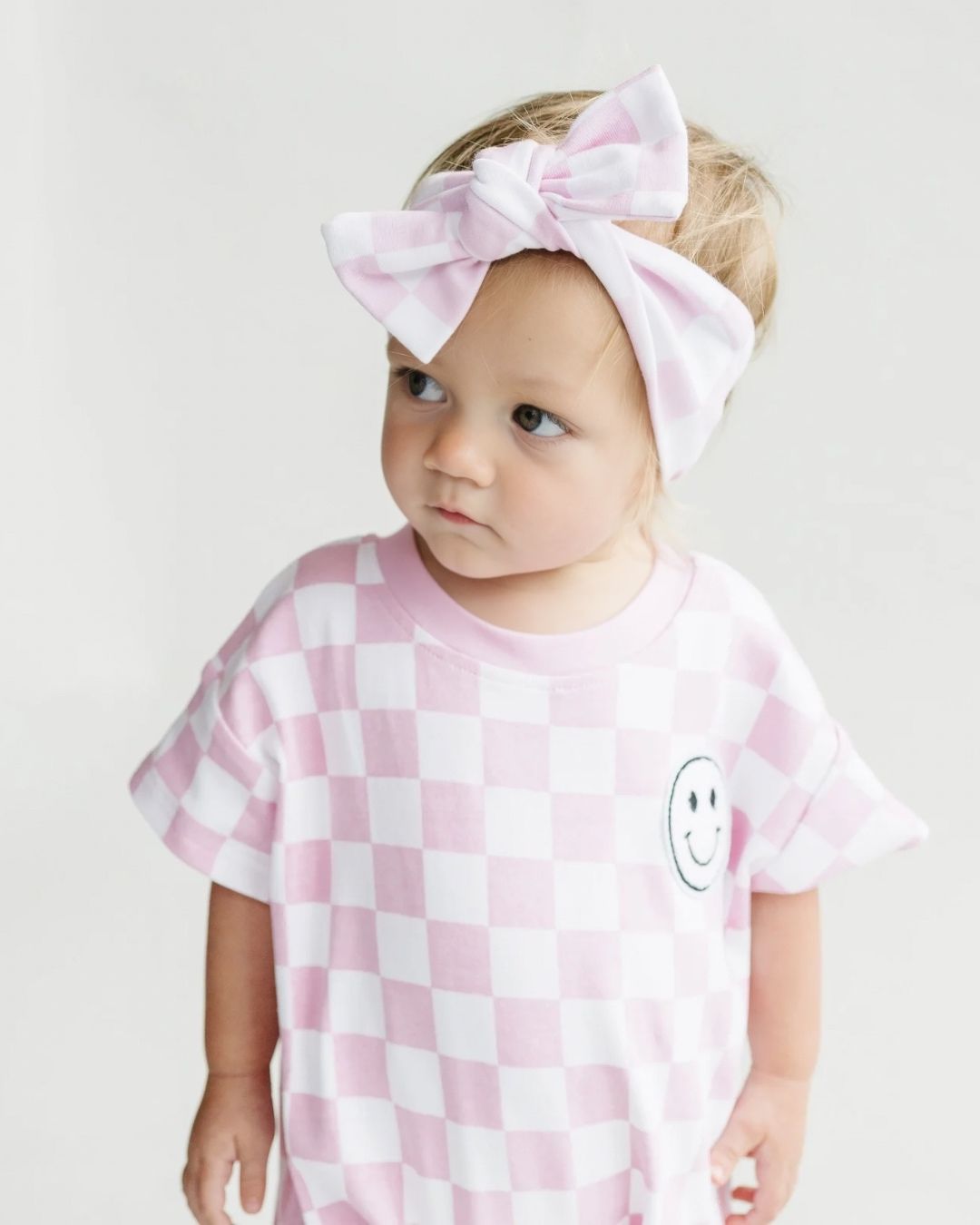 short sleeve bubble romper // checkered smiley pink