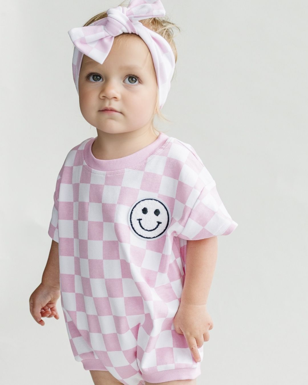 short sleeve bubble romper // checkered smiley pink
