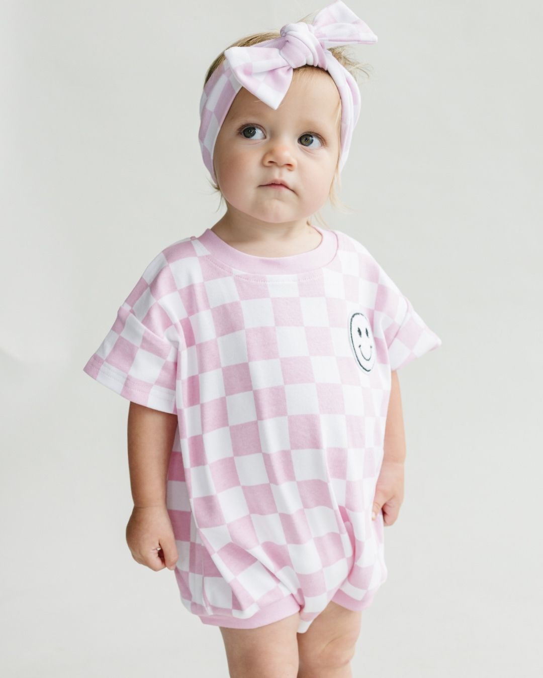 short sleeve bubble romper // checkered smiley pink