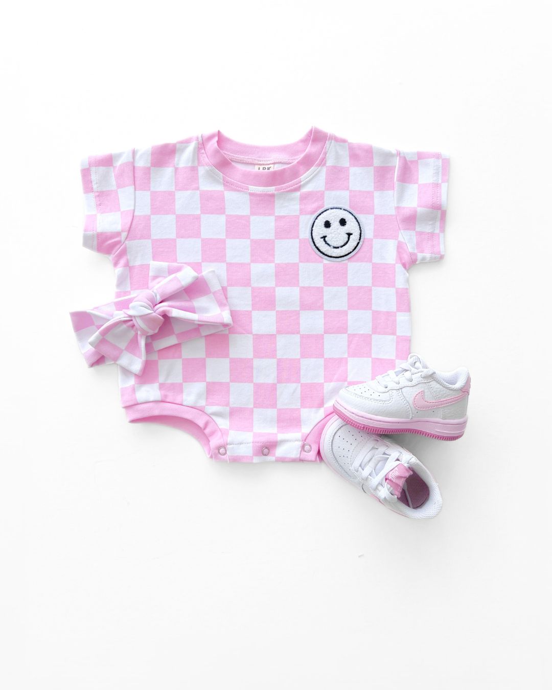 short sleeve bubble romper // checkered smiley pink