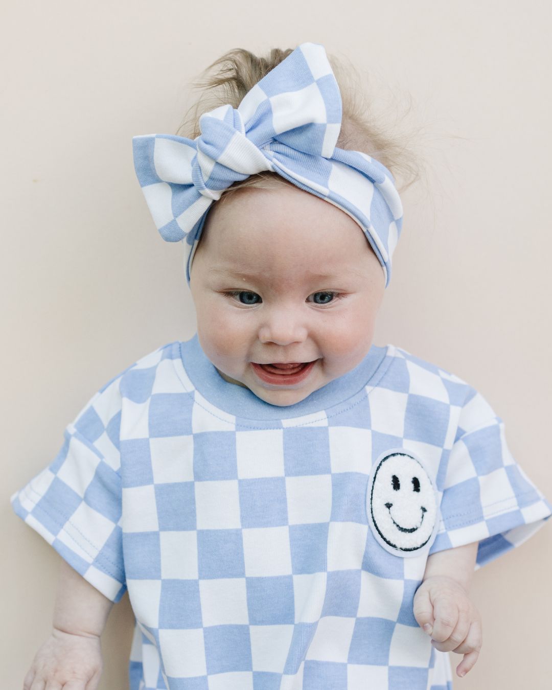 short sleeve bubble romper // checkered smiley blue