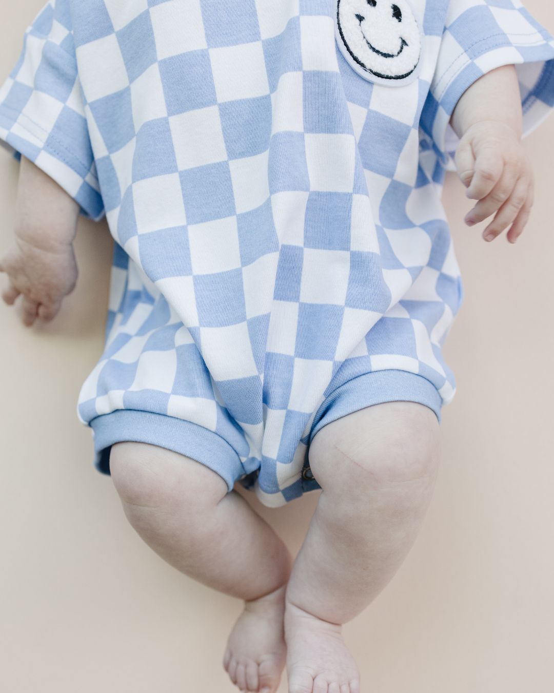 short sleeve bubble romper // checkered smiley blue