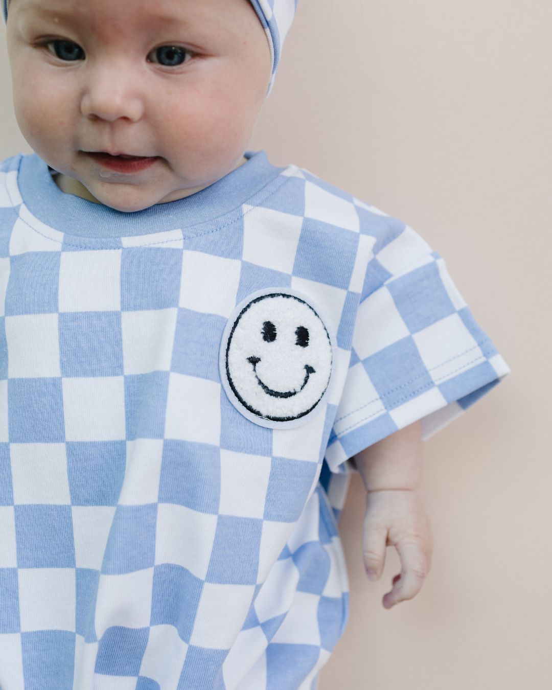 short sleeve bubble romper // checkered smiley blue