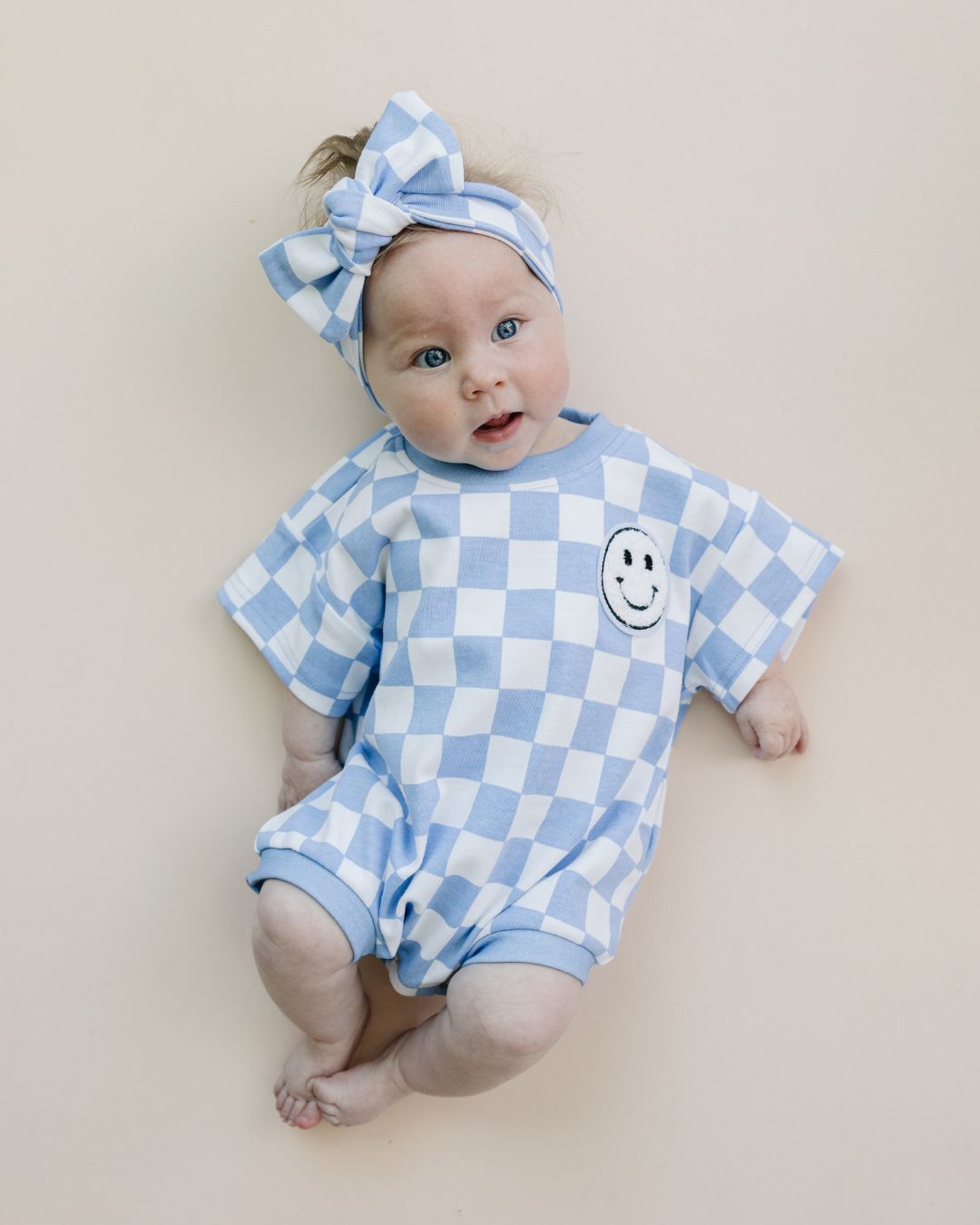 short sleeve bubble romper // checkered smiley blue