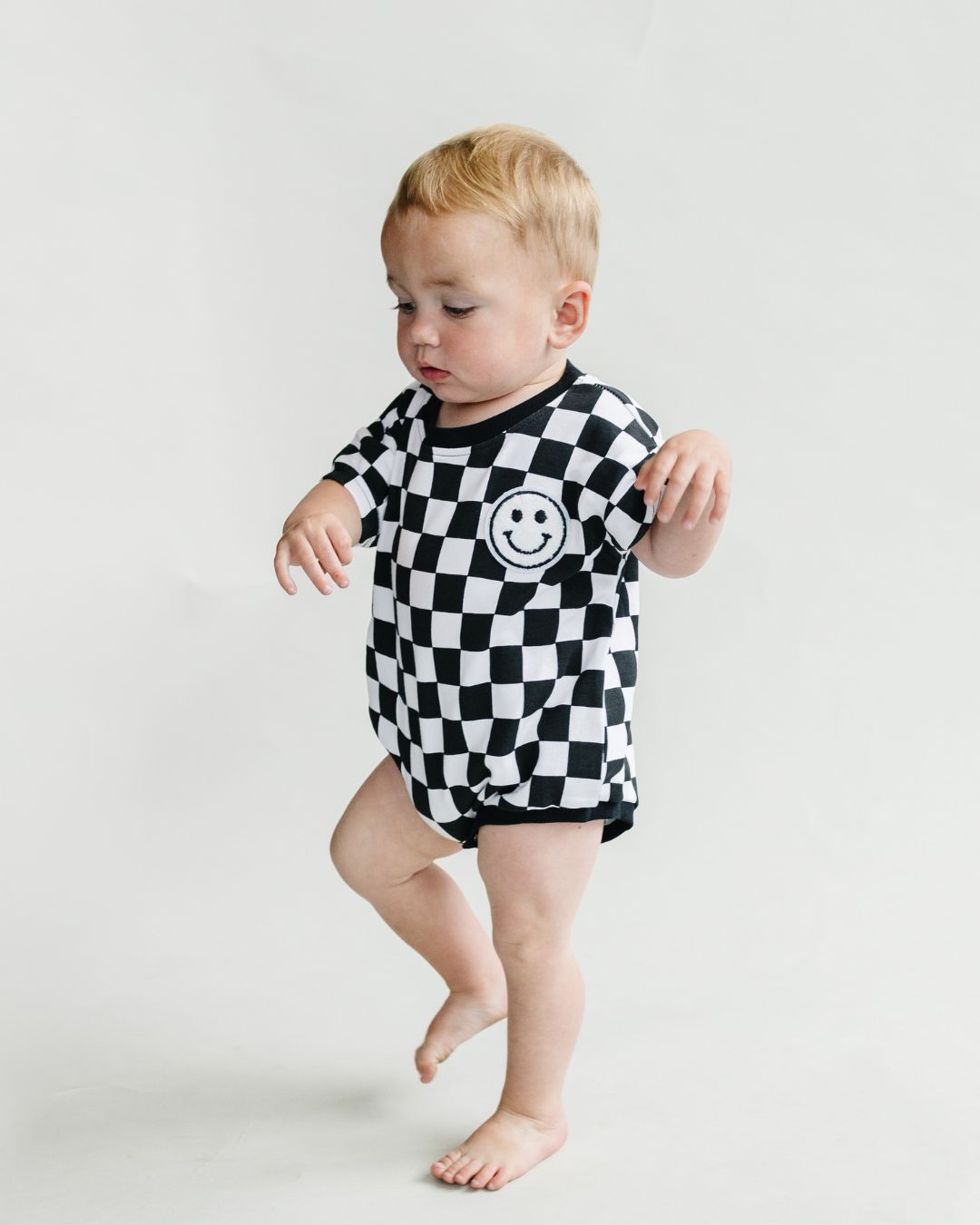 short sleeve bubble romper // checkered smiley black