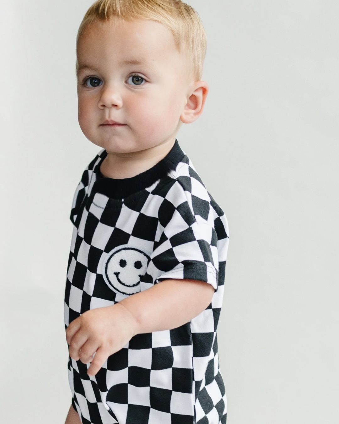 short sleeve bubble romper // checkered smiley black