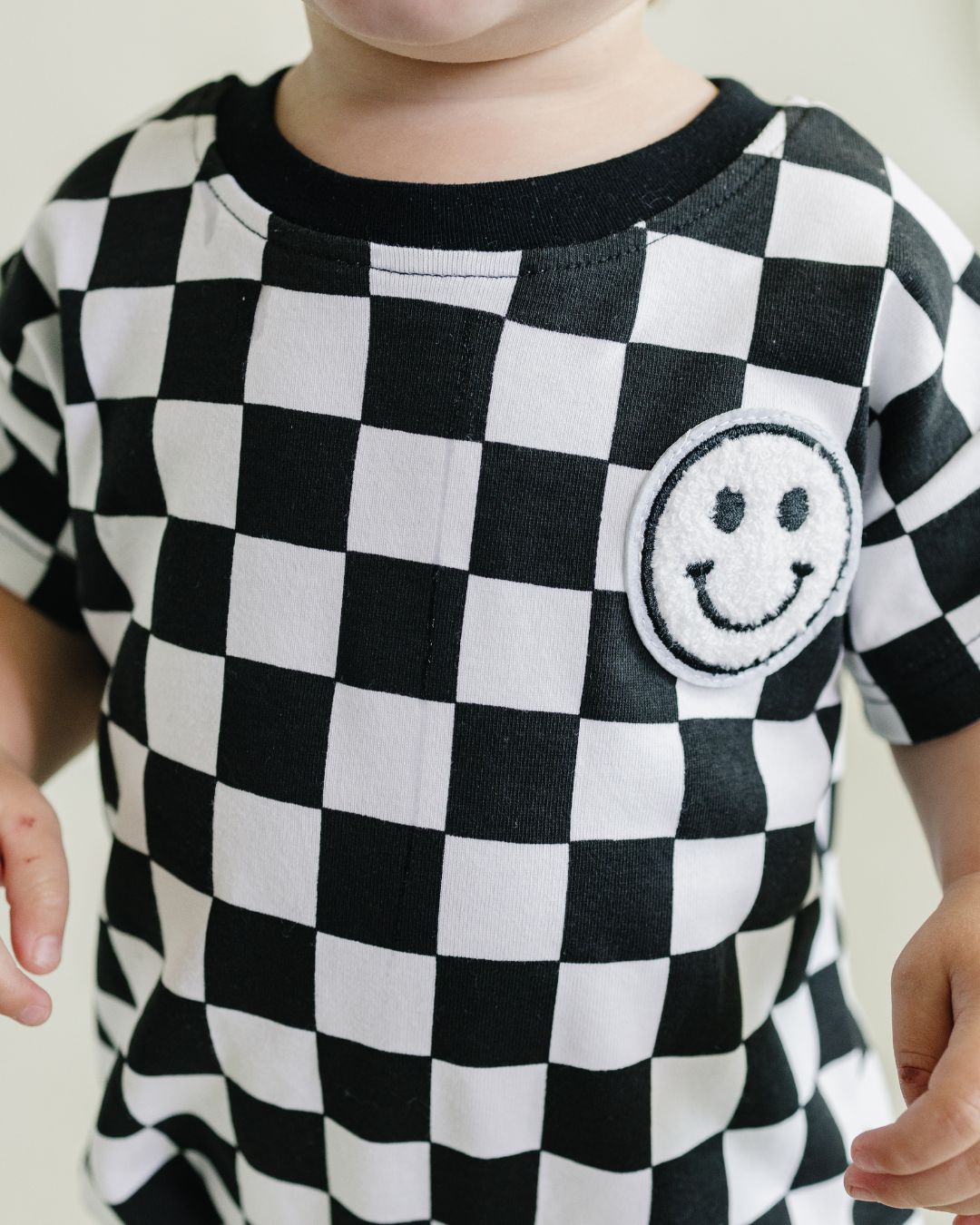 short sleeve bubble romper // checkered smiley black