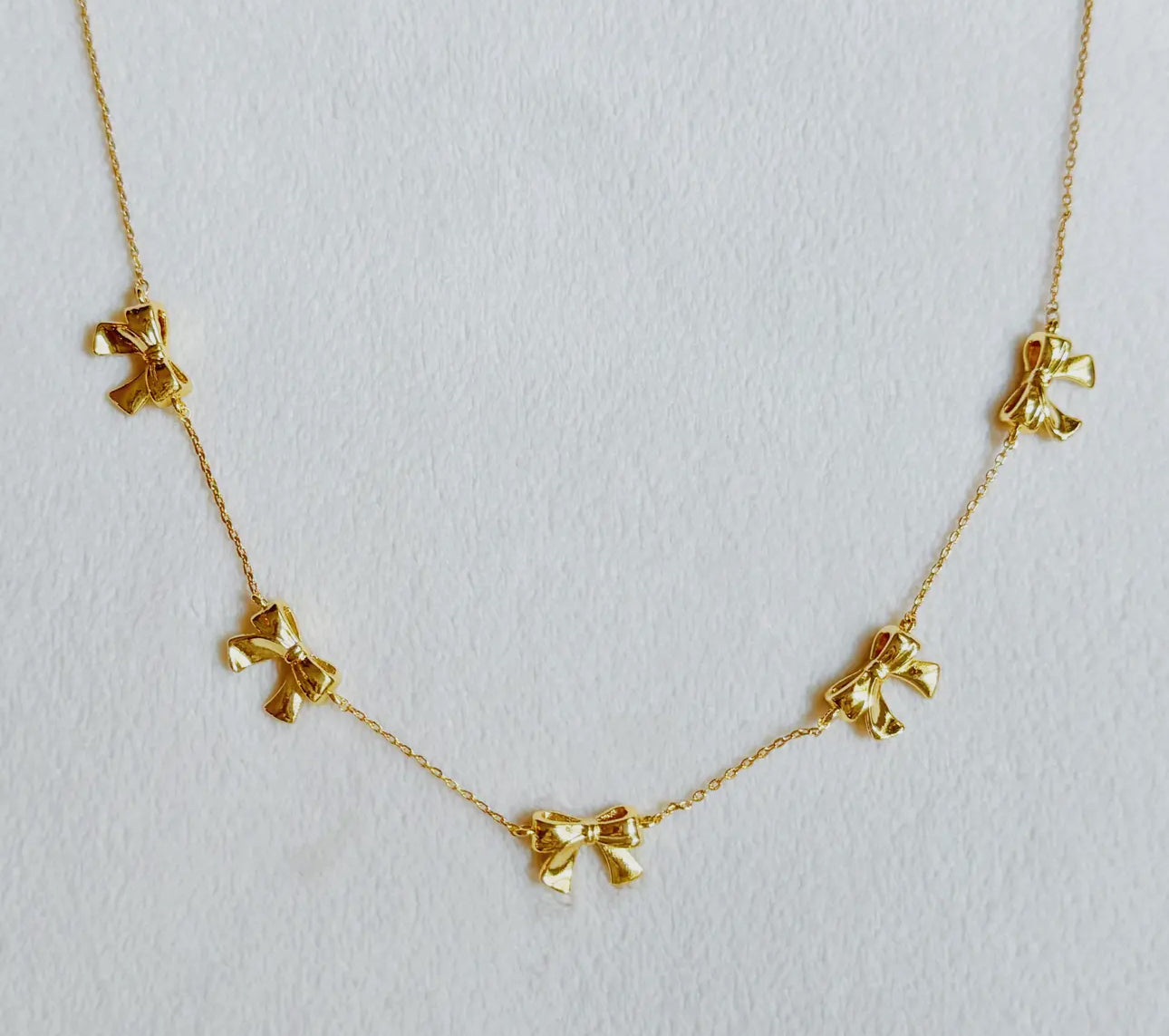 gold multi bows necklace